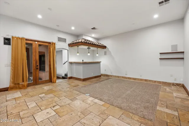a living room with furniture and kitchen view