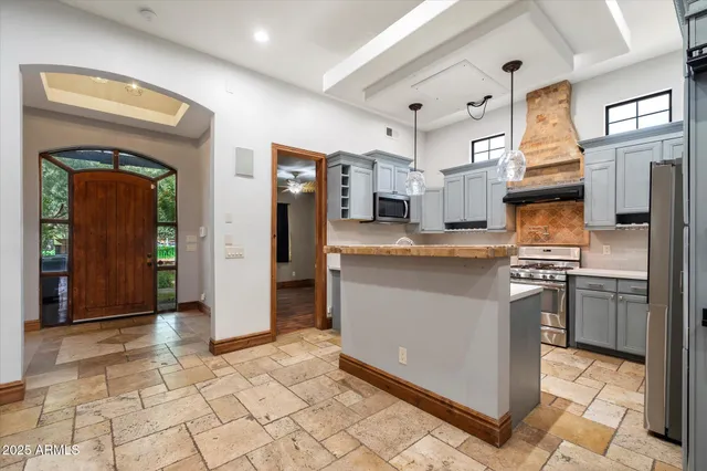 a kitchen with stainless steel appliances granite countertop a sink a stove and a microwave