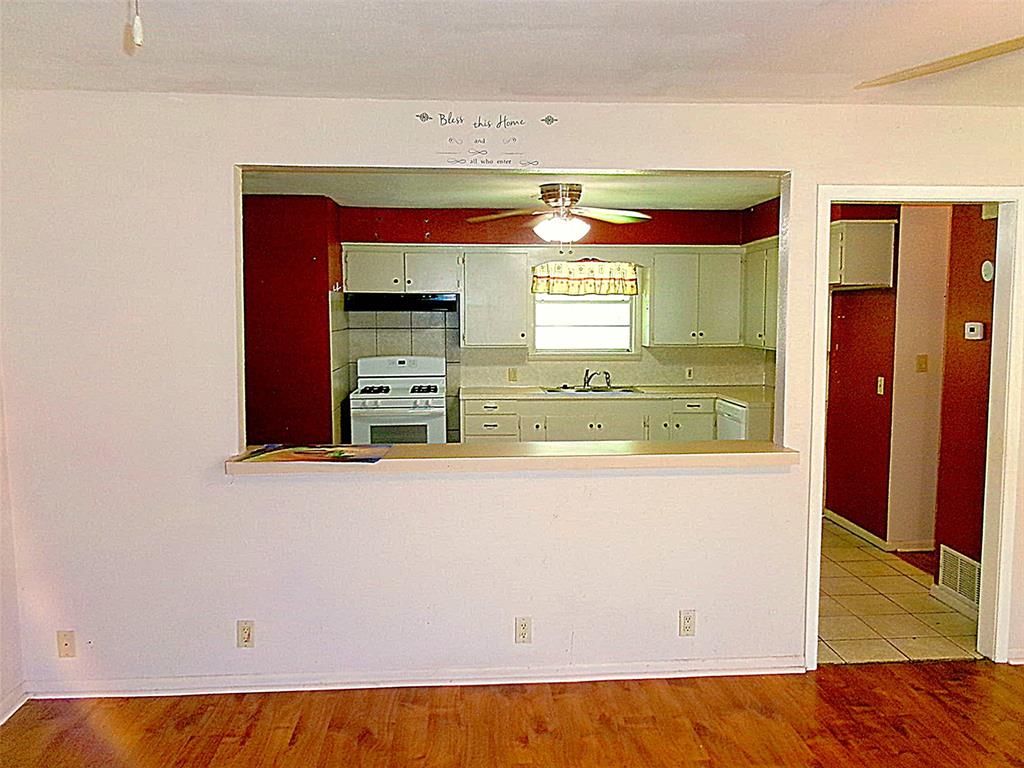 200 West Spencer Street Bangs, TX 76823 - Photo 6 of 19 Living room with pass-through to dining area & kitchen