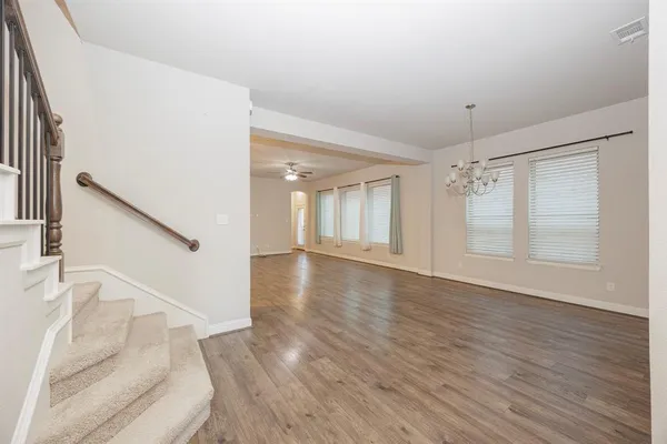 a view of entryway and hall with wooden floor