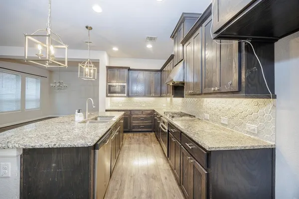 a kitchen with a stove sink and refrigerator