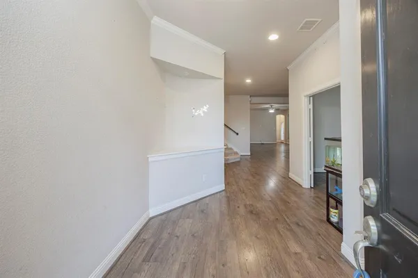 a view of a hallway with wooden floor