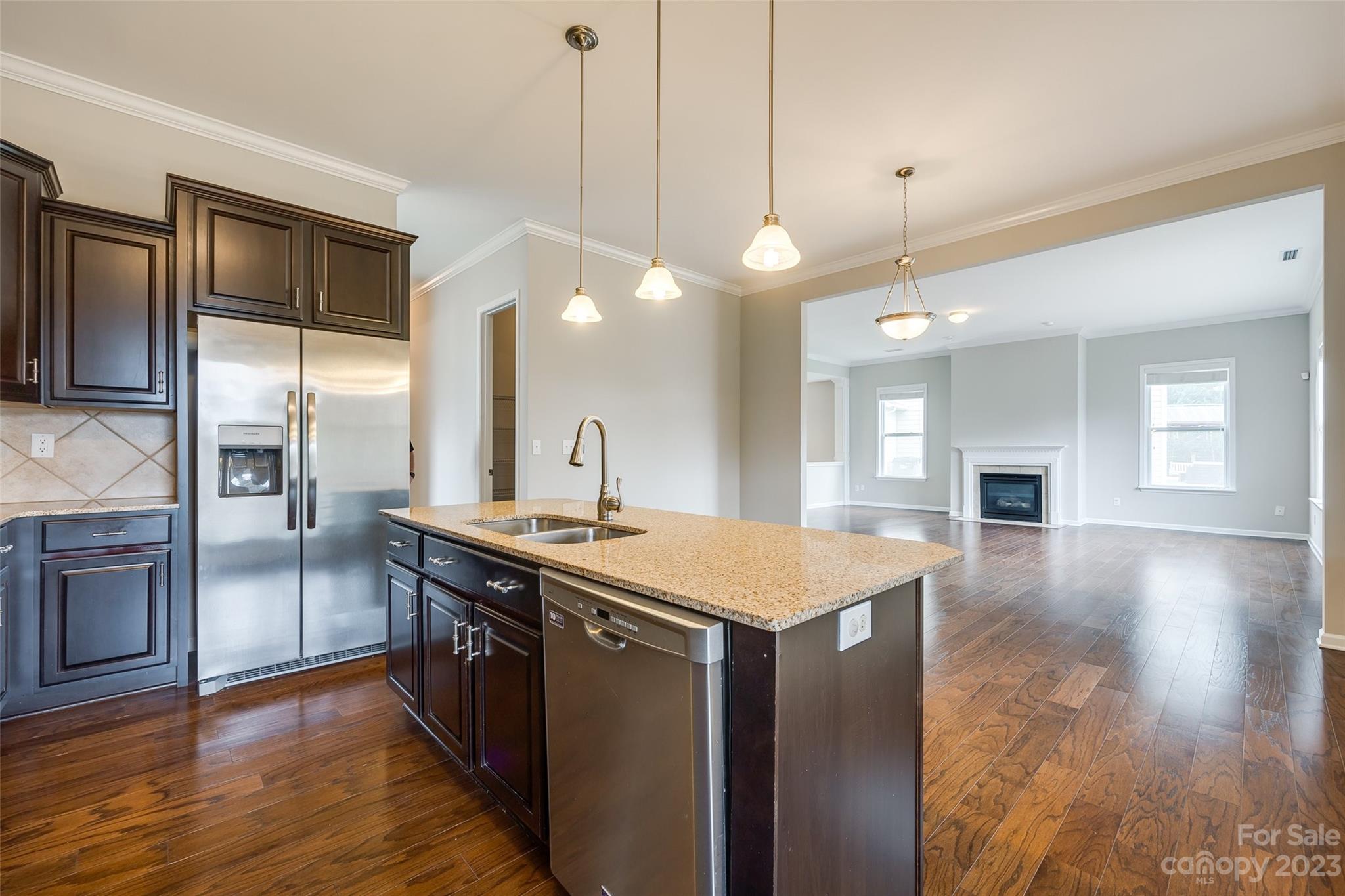 4025 Orchid Way Tega Cay, SC 29708 - Photo 15 of 44 a kitchen with a stove a sink a refrigerator and a fireplace