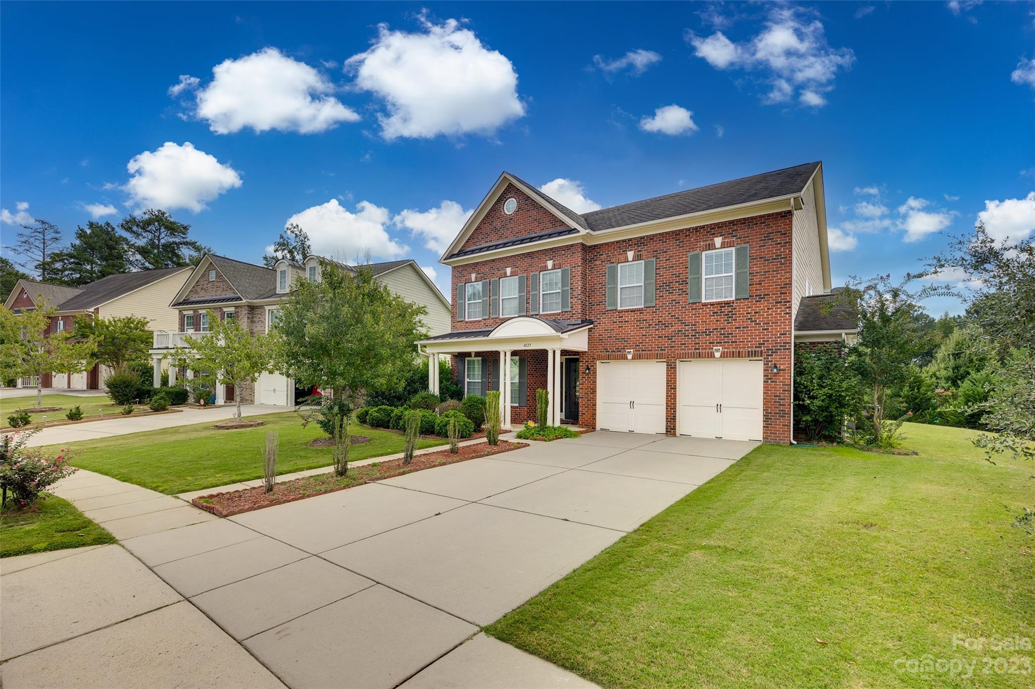 4025 Orchid Way Tega Cay, SC 29708 - Photo 2 of 44 a front view of a house with a yard and trees