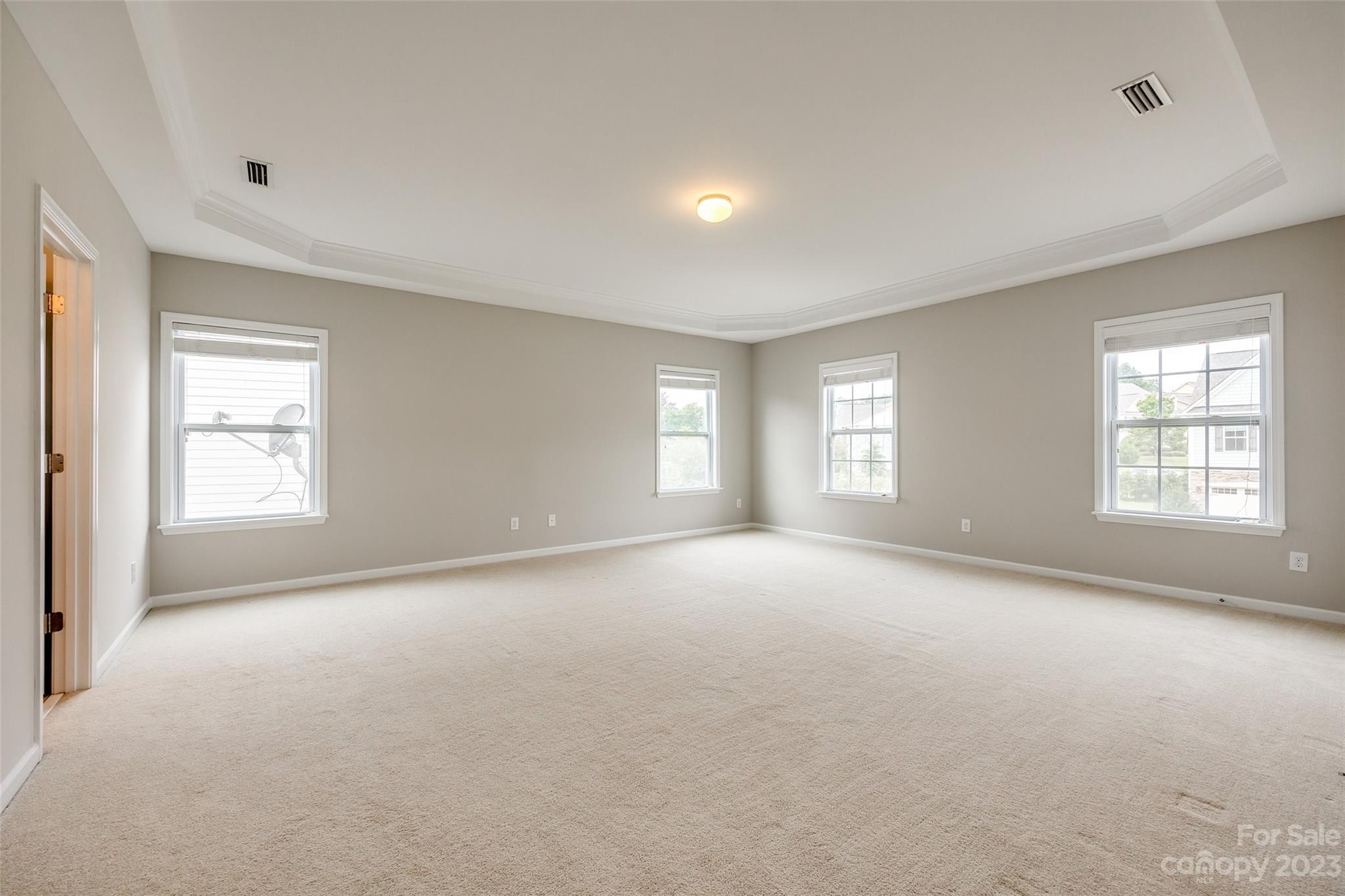 4025 Orchid Way Tega Cay, SC 29708 - Photo 26 of 44 a view of a big room with windows and chandelier fan