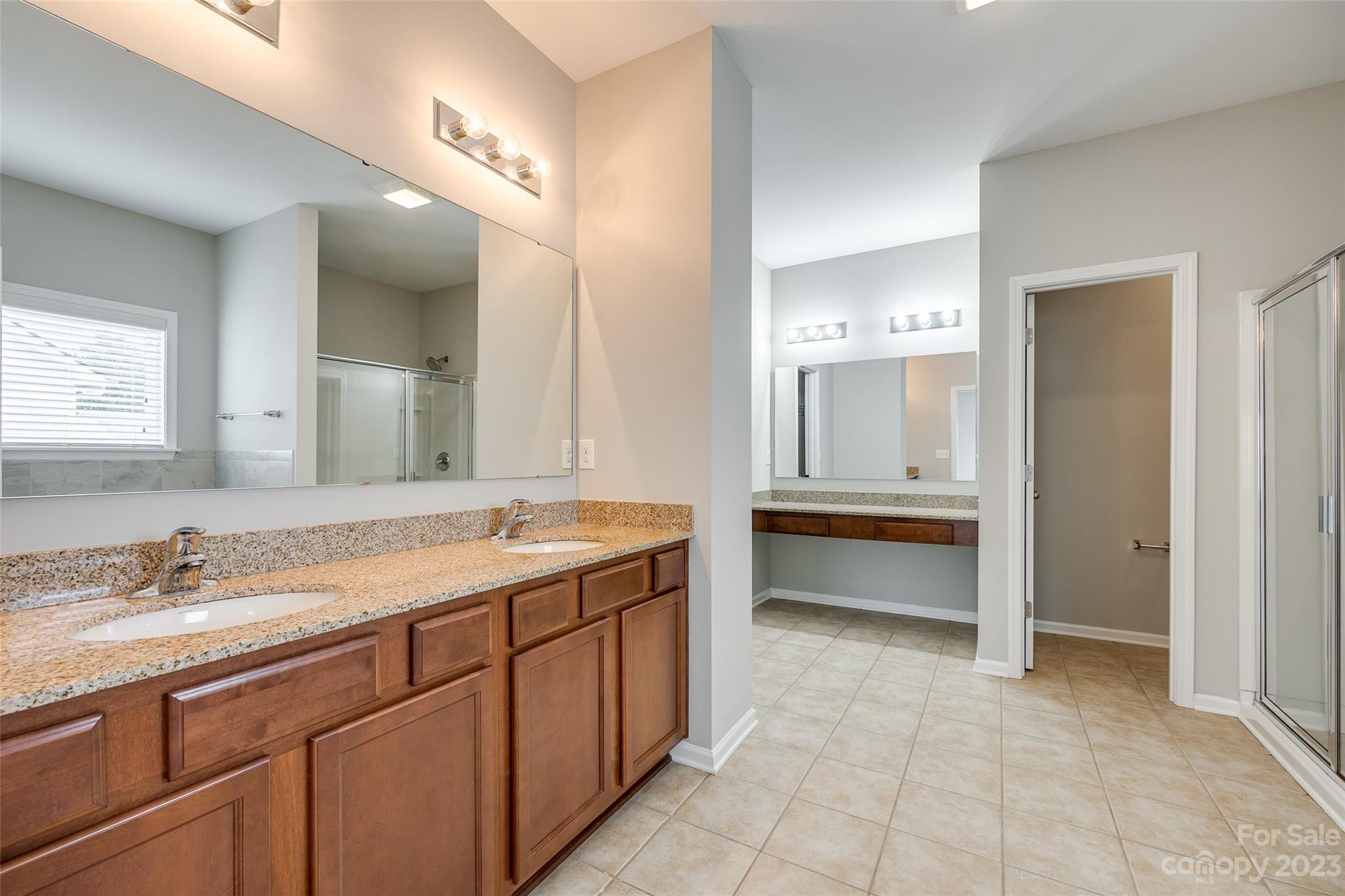 4025 Orchid Way Tega Cay, SC 29708 - Photo 27 of 44 a bathroom with a granite countertop sink mirror and