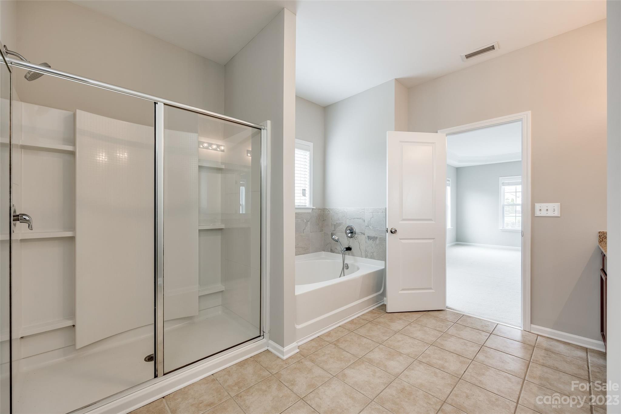 4025 Orchid Way Tega Cay, SC 29708 - Photo 28 of 44 a bathroom with a tub shower and sink