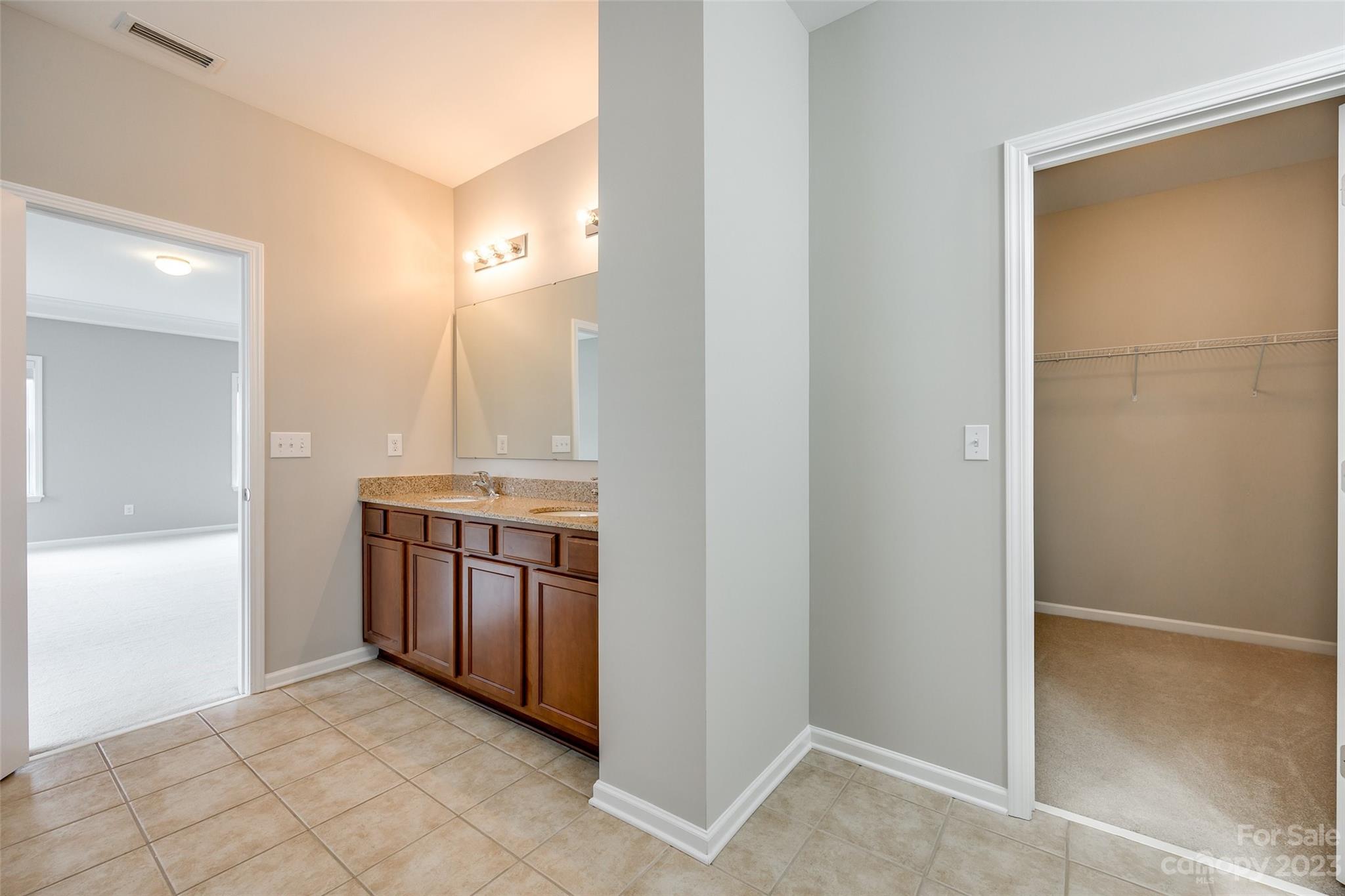 4025 Orchid Way Tega Cay, SC 29708 - Photo 29 of 44 a bathroom with a granite countertop sink and a mirror