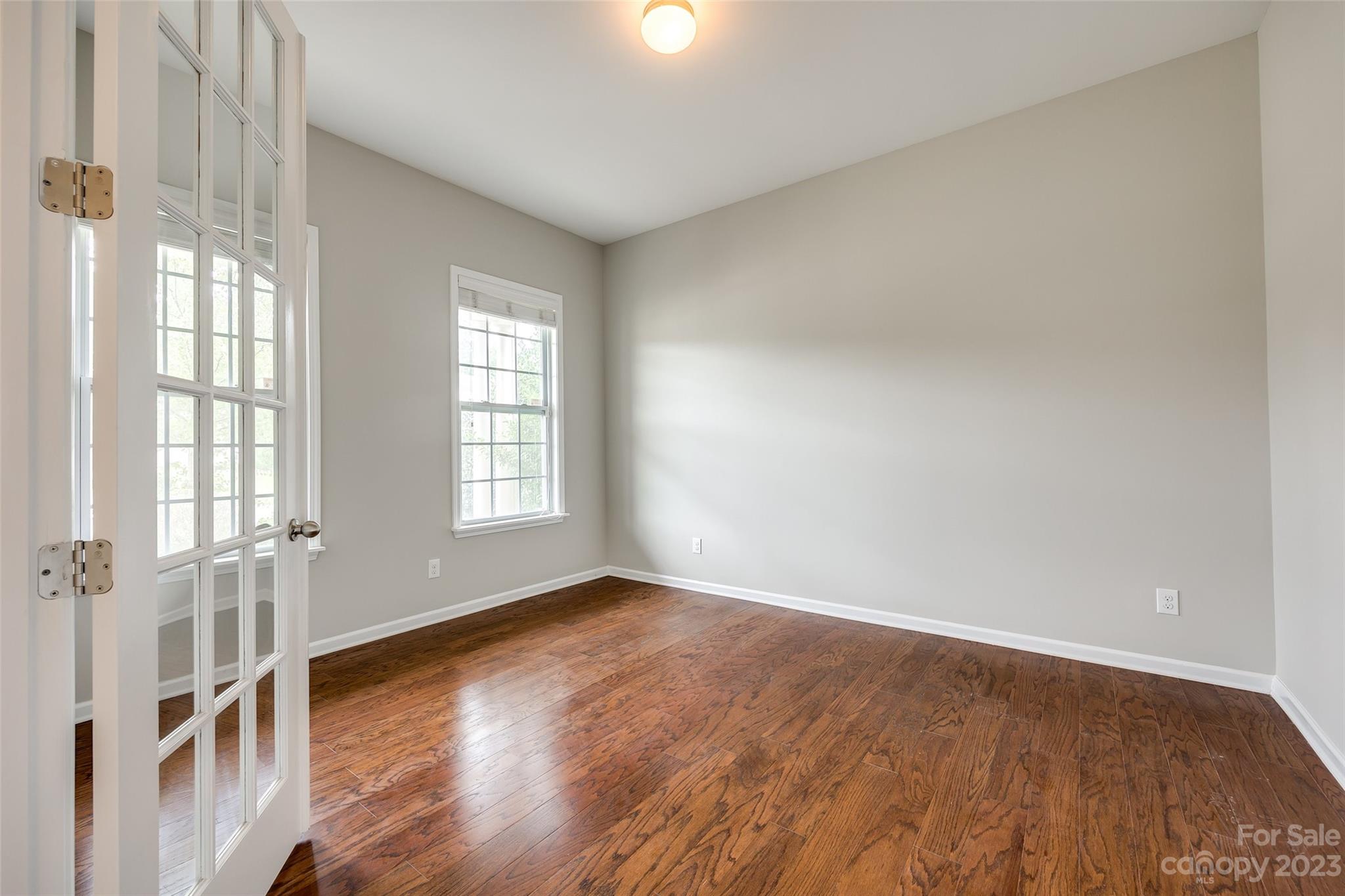 4025 Orchid Way Tega Cay, SC 29708 - Photo 6 of 44 an empty room with wooden floor and windows