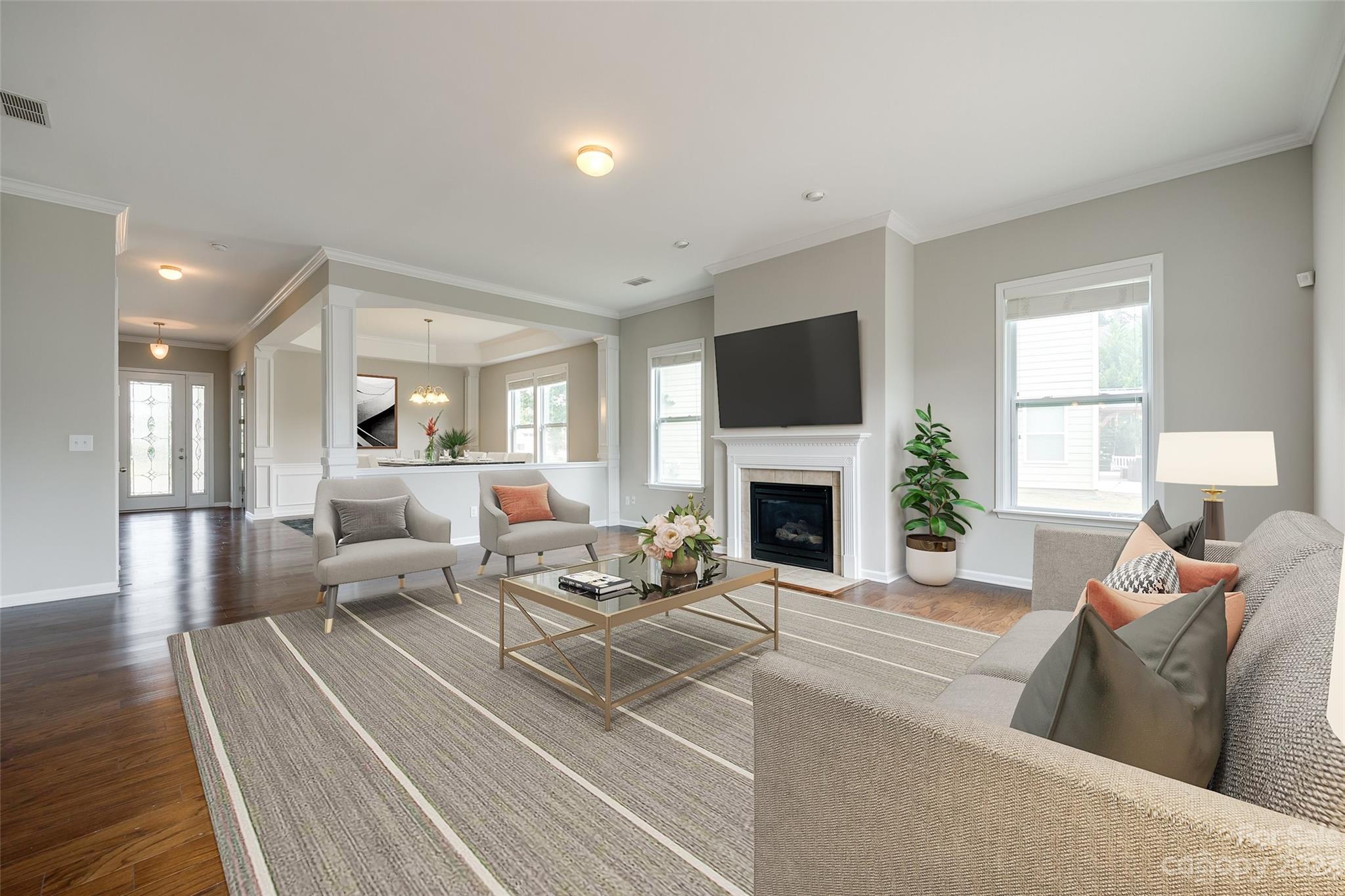 4025 Orchid Way Tega Cay, SC 29708 - Photo 9 of 44 a living room with furniture a fireplace and a flat screen tv