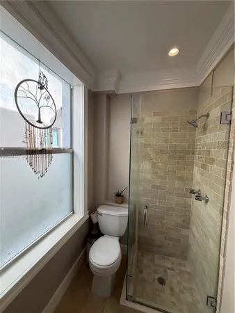 a bathroom with a toilet a sink and a shower