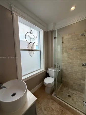 a bathroom with a sink toilet a mirror and shower