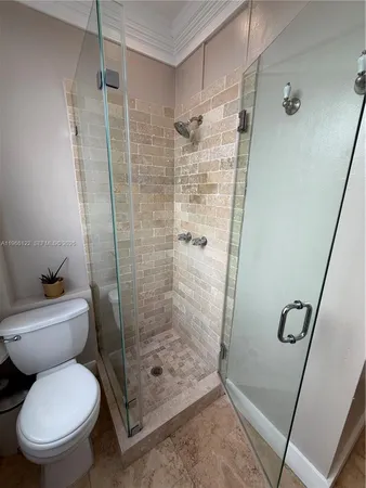a bathroom with a toilet and a shower