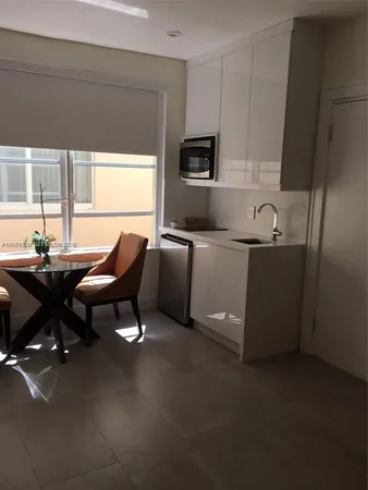 a living room with furniture a flat screen tv and a window