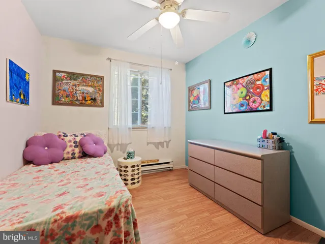 a bedroom with a bed and a painting on the wall