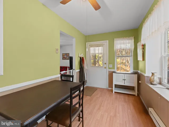 a living room with furniture and a flat screen tv with wooden floor
