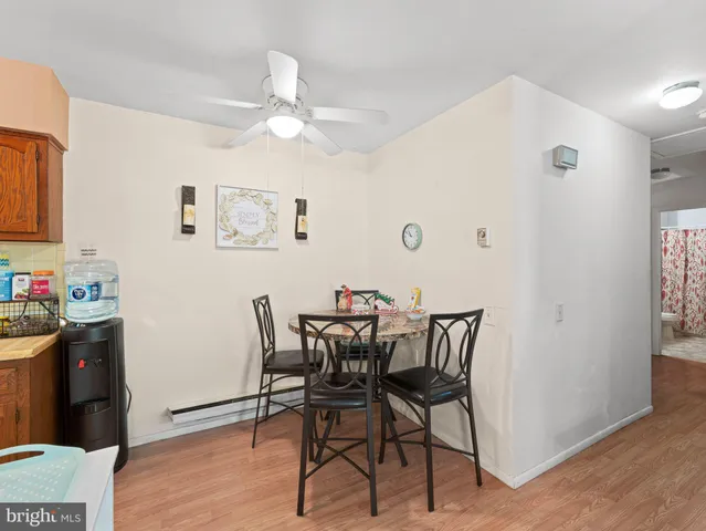 a kitchen with granite countertop a stove dining table and chairs