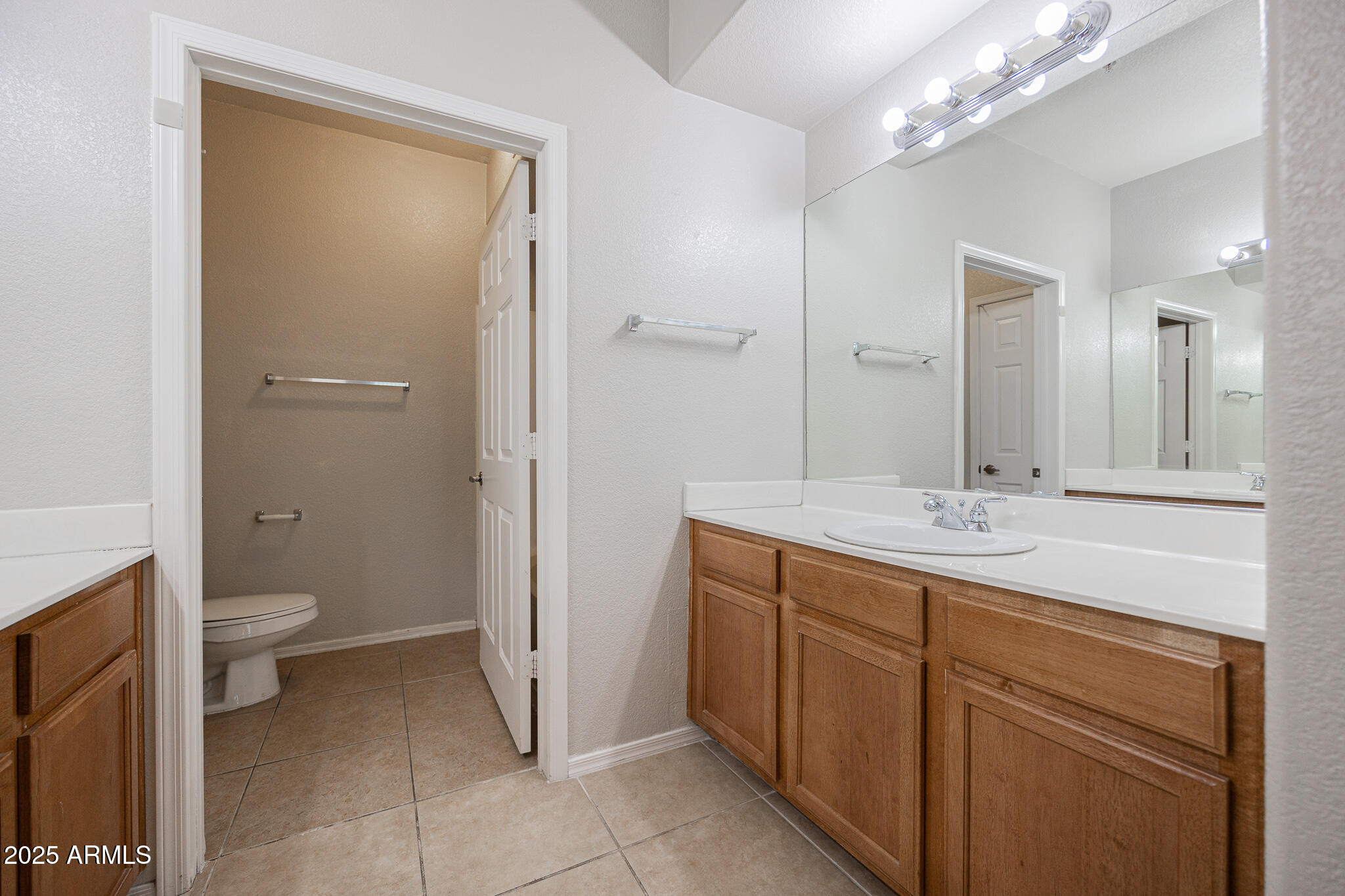 435 West Rio Salado Parkway, Unit 229 Tempe, AZ 85281 - Photo 17 of 26 a bathroom with a sink a toilet and a mirror