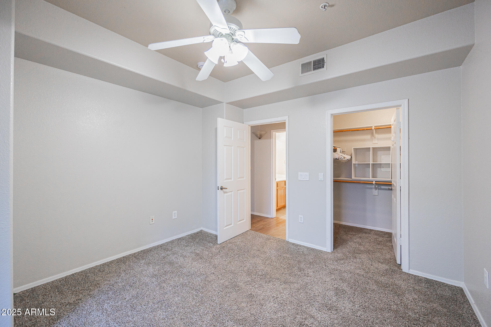 435 West Rio Salado Parkway, Unit 229 Tempe, AZ 85281 - Photo 21 of 26 an empty room with a ceiling fan and carpet