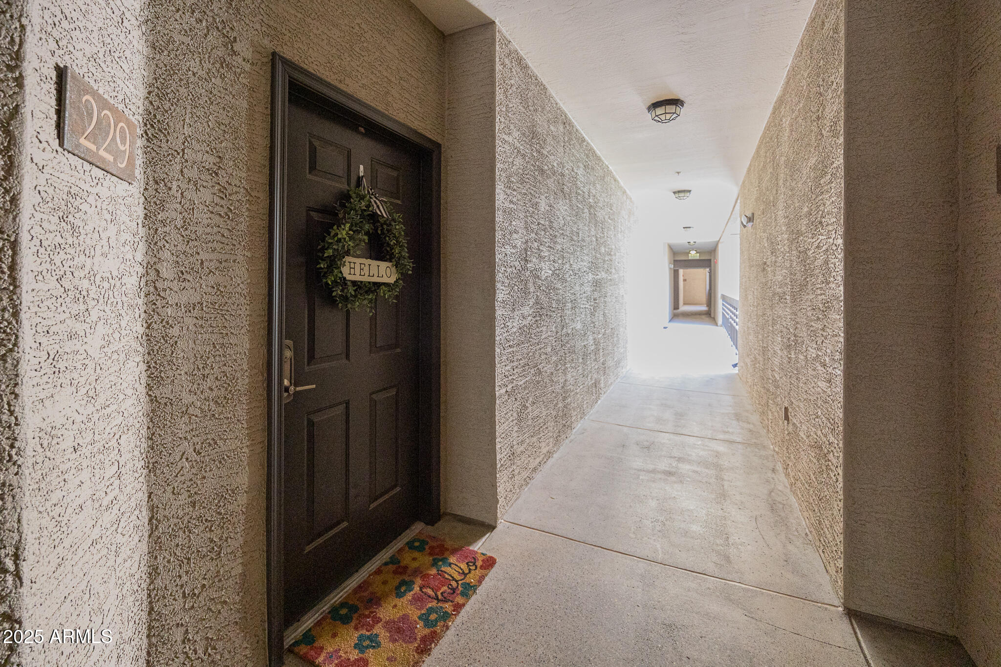 435 West Rio Salado Parkway, Unit 229 Tempe, AZ 85281 - Photo 3 of 26 a view of a hallway with wooden floor and a bathroom