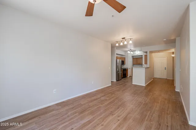 wooden floor in an empty room with a kitchen