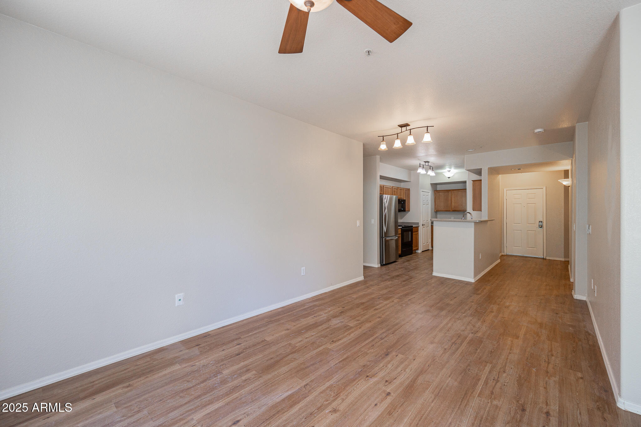 435 West Rio Salado Parkway, Unit 229 Tempe, AZ 85281 - Photo 7 of 26 wooden floor in an empty room with a kitchen