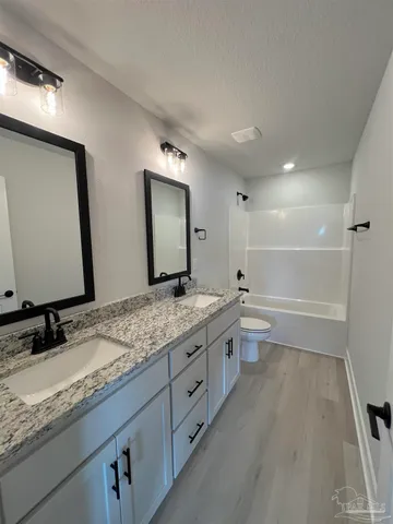 a bathroom with a granite countertop sink mirror and double