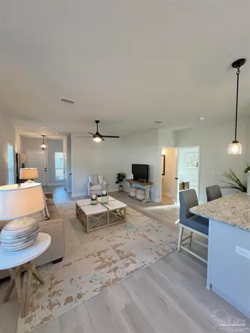 a living room with furniture and a wooden floor