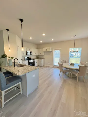 a living room with furniture a dining table and chairs