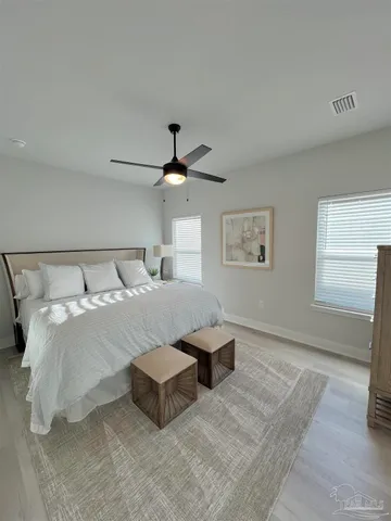 a bedroom with a bed and a ceiling fan