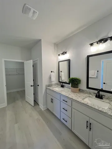 a spacious bathroom with a granite countertop sink mirror and a