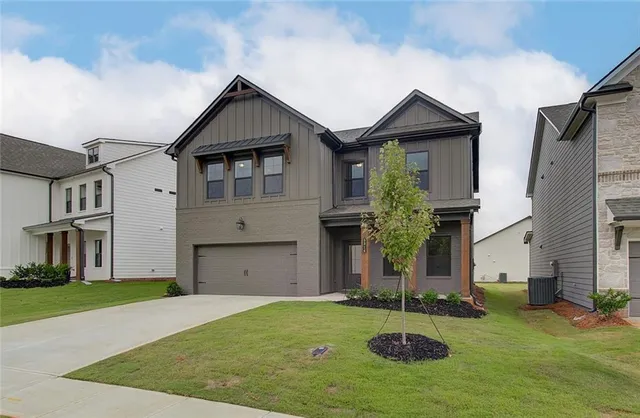 a front view of a house with a yard and garage