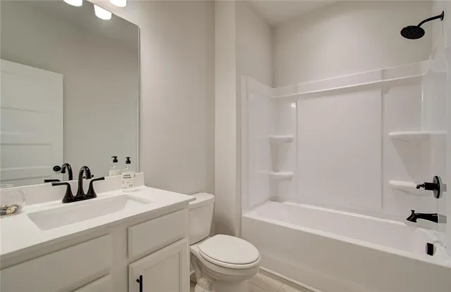 a bathroom with a sink toilet vanity and tub