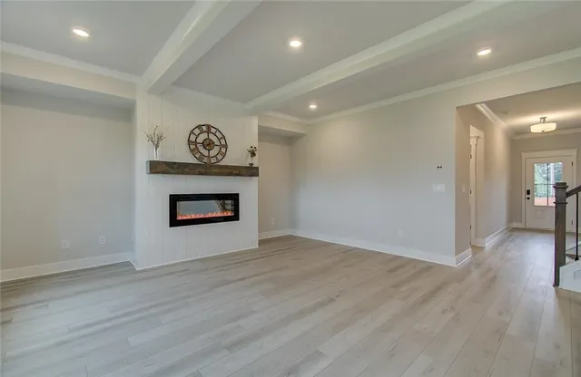 a view of an empty room and wooden floor