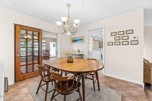 a large white kitchen with a large window and stainless steel appliances