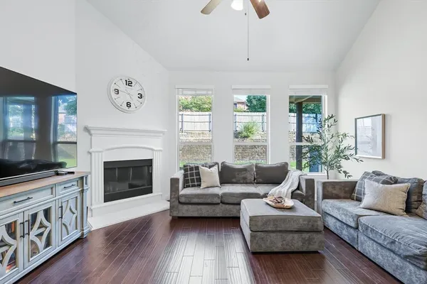 a living room with furniture a flat screen tv and a fireplace