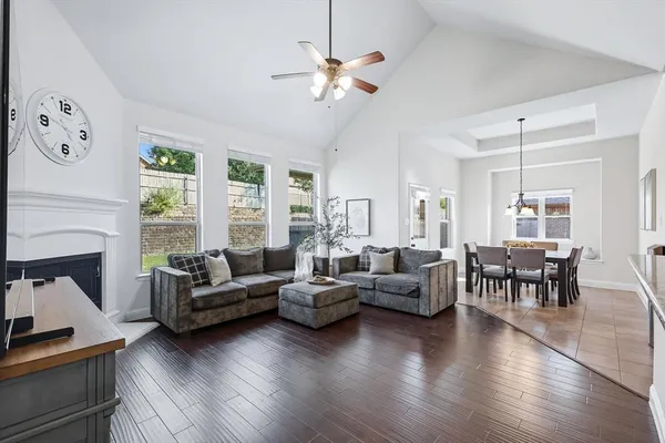 a living room with fireplace furniture and a large window