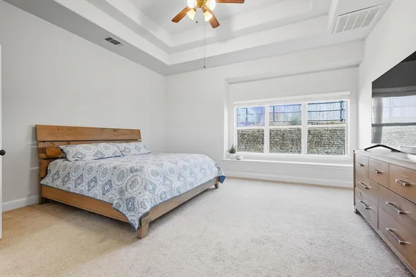 a bedroom with a bed and a large window