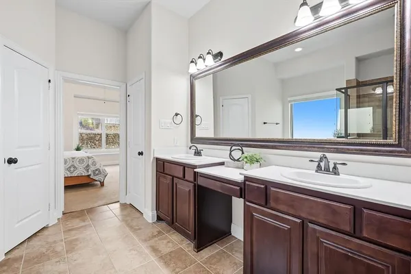 a en suite bathroom with a sink double vanity and a mirror