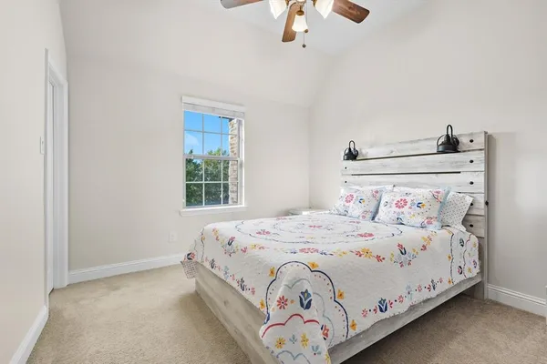 a bedroom with a bed and chandelier