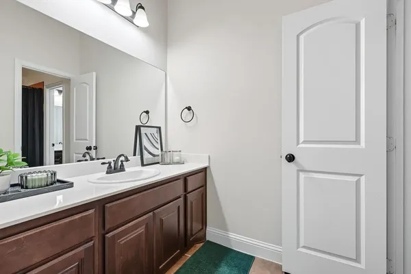 a bathroom with a double vanity sink and a mirror