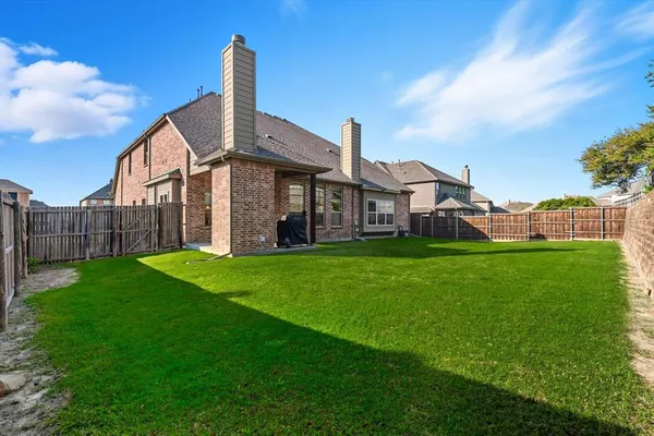 a front view of house with yard barbeque oven and green space