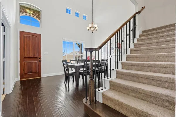 a view of a dining room with wooden floor and stairs