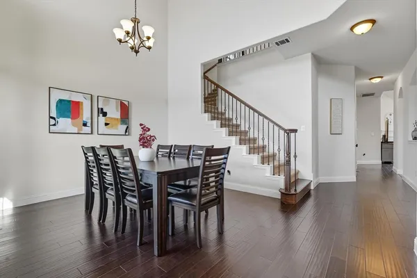 a view of a dining room with furniture wooden floor and chandelier