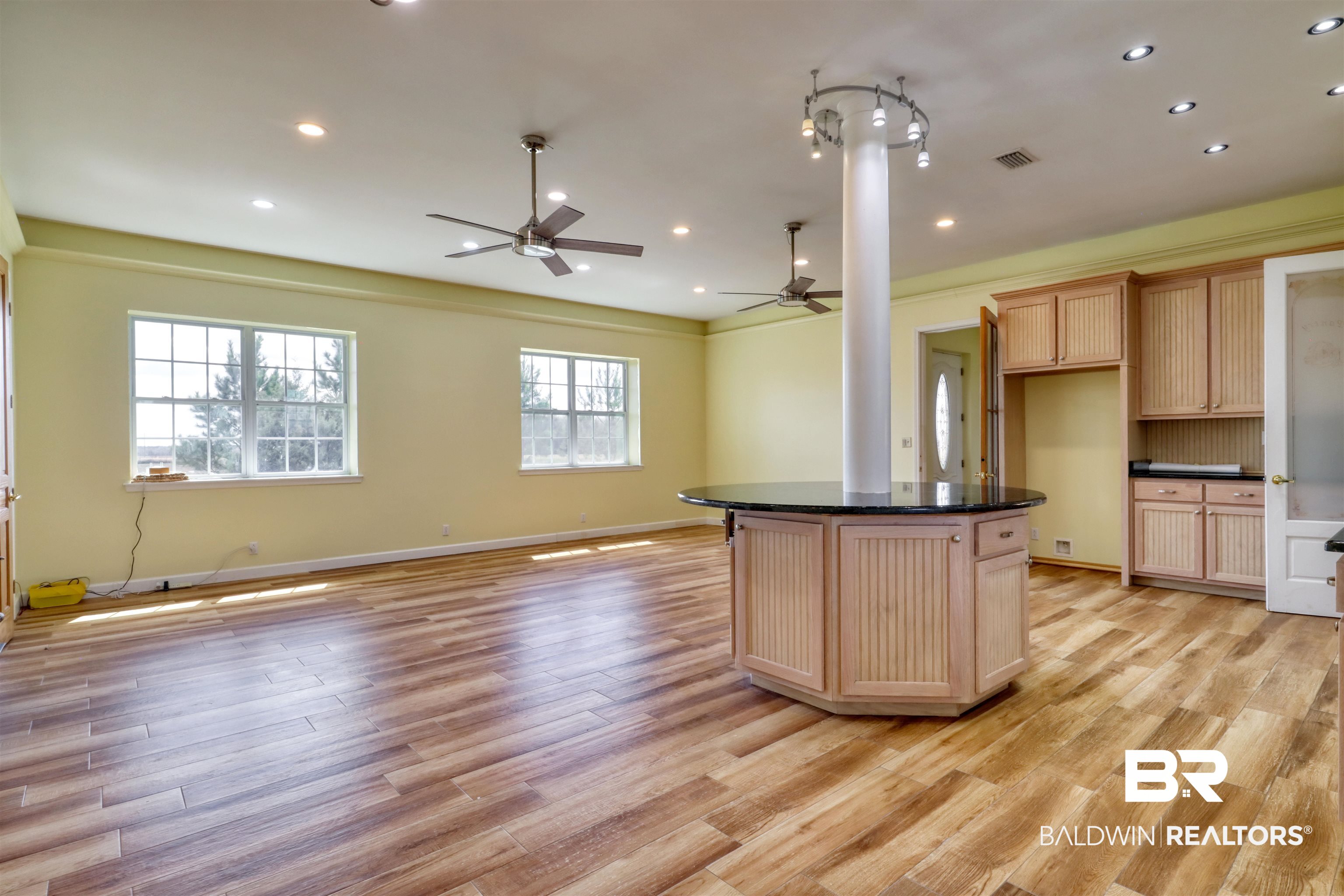 28461 Gardner Road Elberta, AL 36530 - Photo 46 of 46 Kitchen with open floor plan, light wood finish cabinetry, a kitchen island, light wood-style floors, and dark stone counters