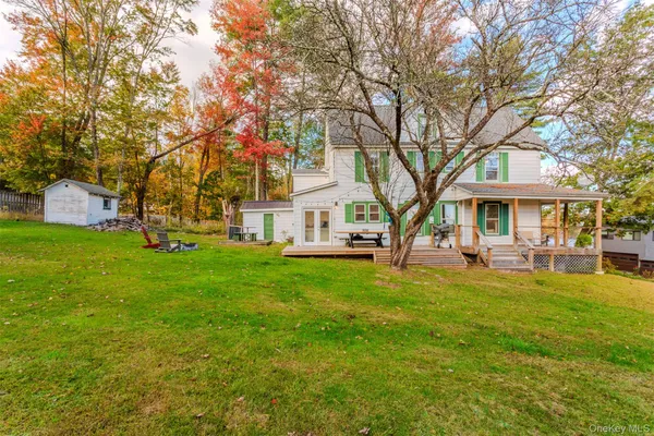 a view of a house with backyard and sitting area