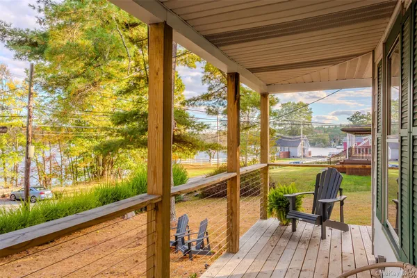 a view of a room with wooden floor and furniture