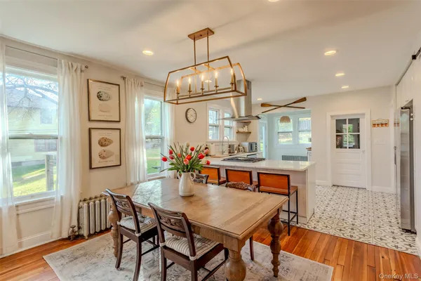 a view of a dining room with furniture and chandelier