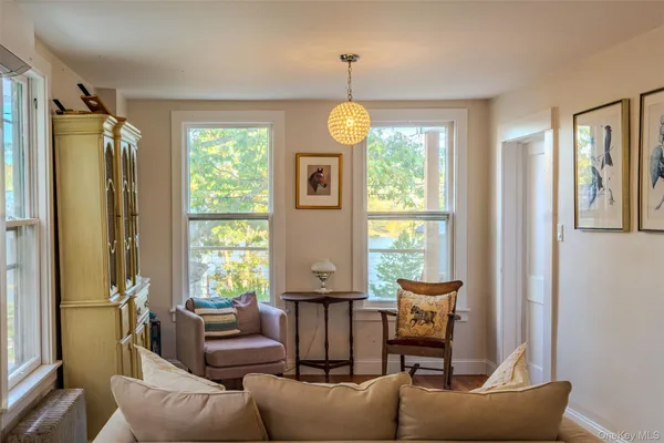 a living room with furniture and a chandelier