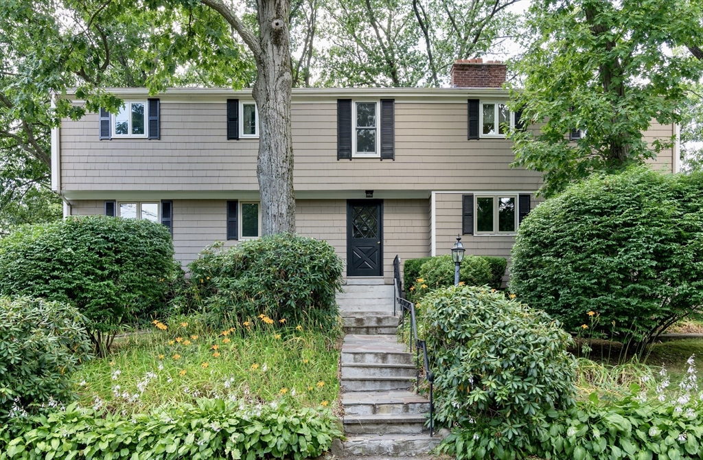 26 Hodge Road Arlington, MA 02474 - Photo 1 of 17 front view of a house with a yard and potted plants
